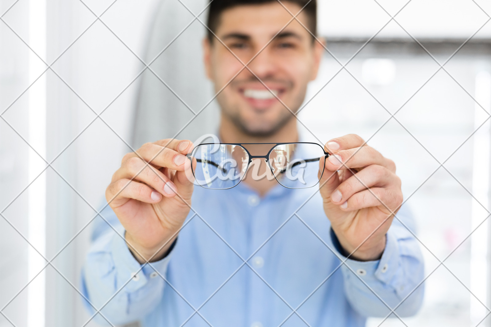 Portrait of handsome young guy showing spectacles - Photos by Canva