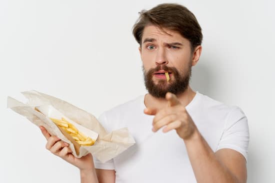 Man Eats French Fries Photos By Canva