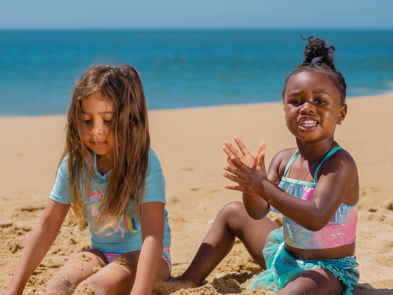 Two Little Girls Playing on Beach Sand - Photos by Canva