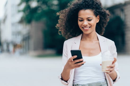 Happy woman walking and texting