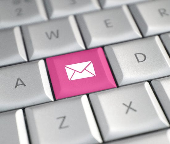 Computer keyboard keys with a fictional pink key with an envelope symbol on it