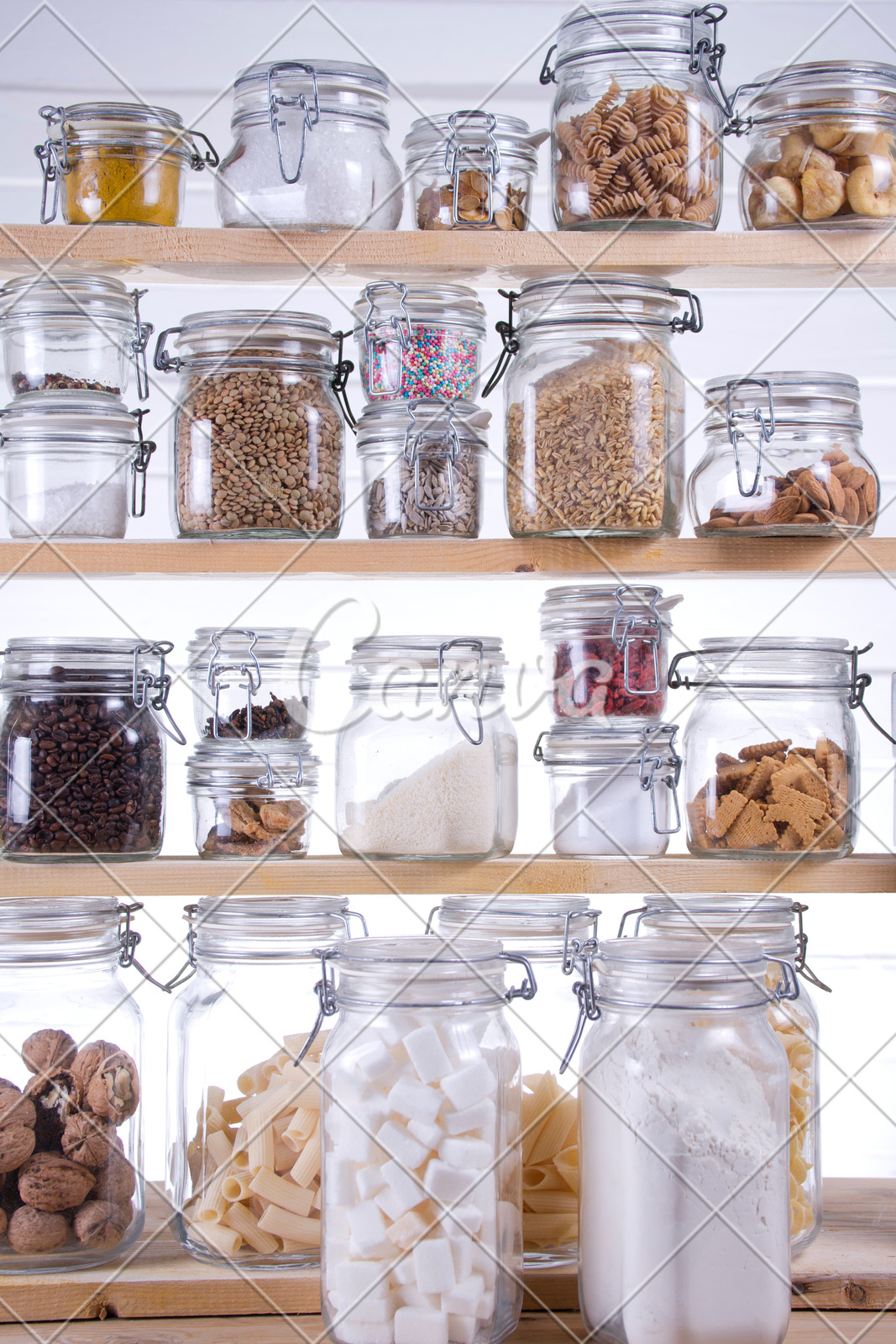 A Pantry Filled With Glass Jars Of Various Ingredients Photos By