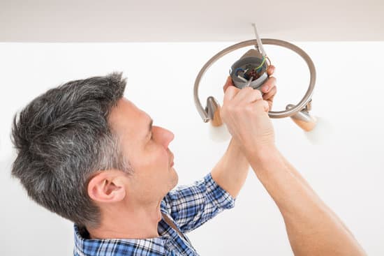 Fixing Of Ceiling Light With Screwdriver Photos By Canva