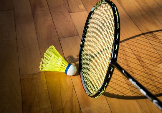 Badminton rackets and shuttlecock on court - Photos by Canva