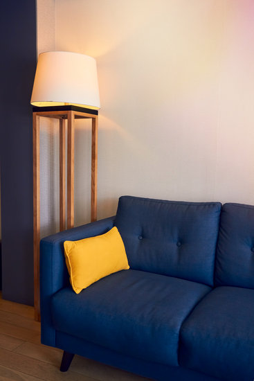 Yellow And Navy Blue Painting Above Sofa In Modern Living