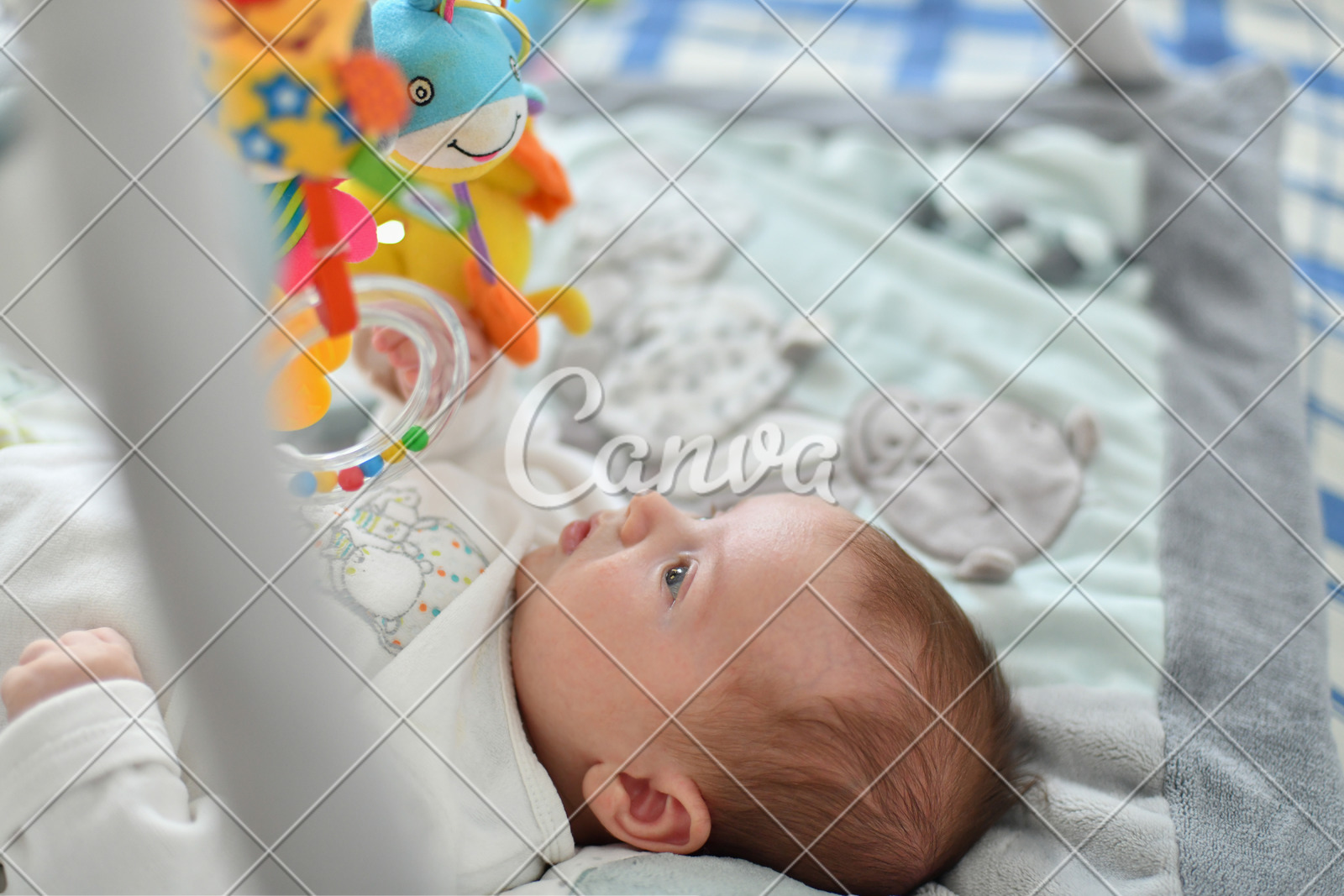 Baby Boy Playing With Hanging Toys On Developing Mat Photos By Canva