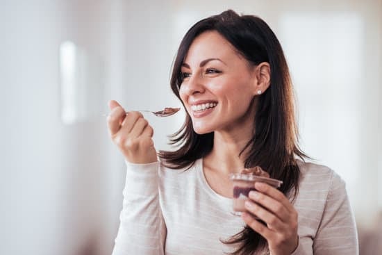 Happy woman eating pudding.