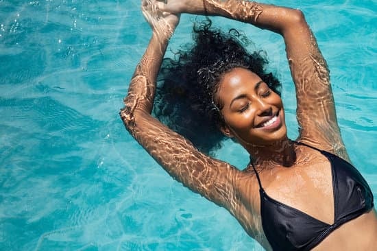 Happy Woman Relaxing in Swimming Pool