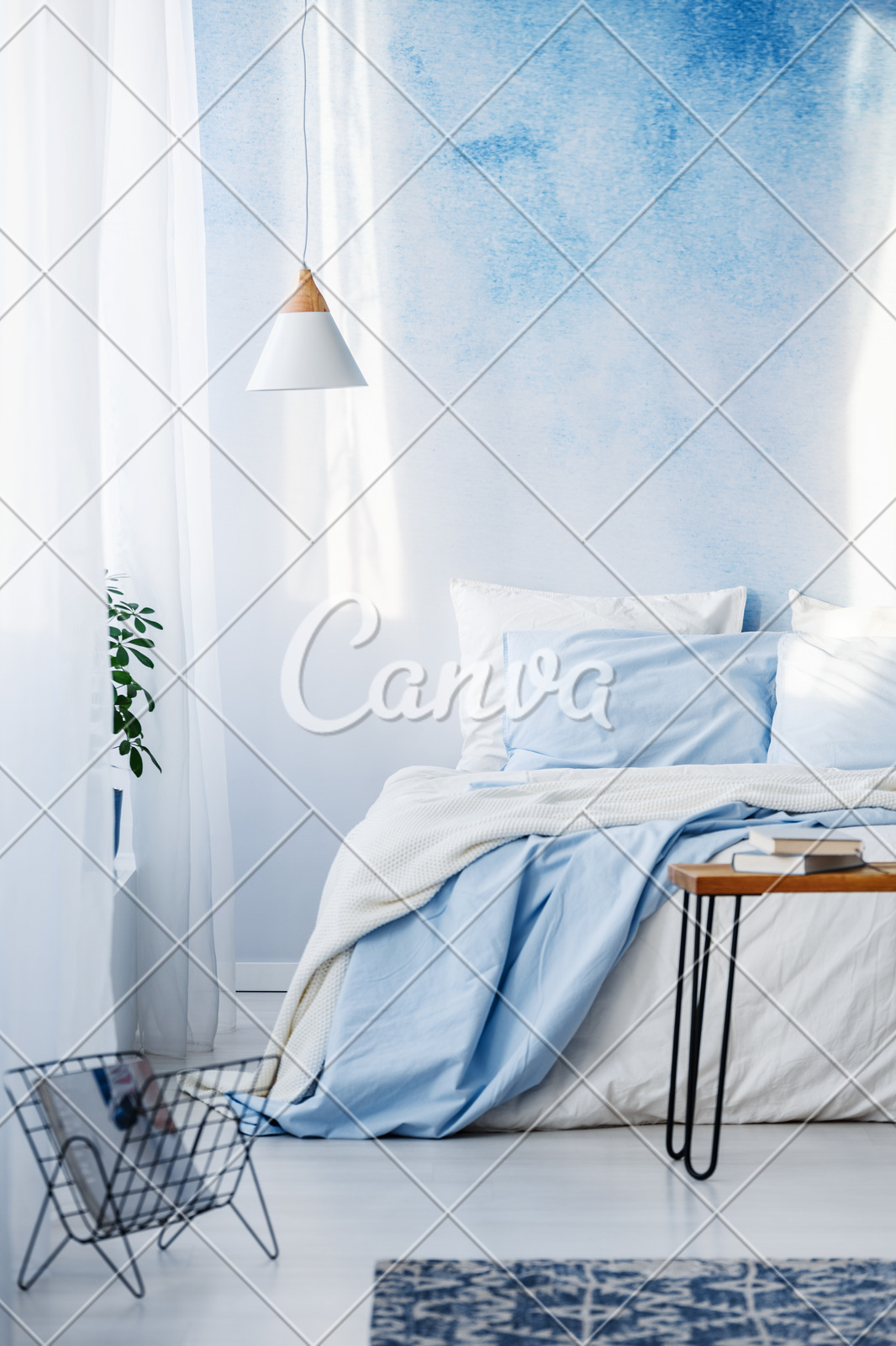 Books On Table And White And Blue Bedding On Bed In Pastel