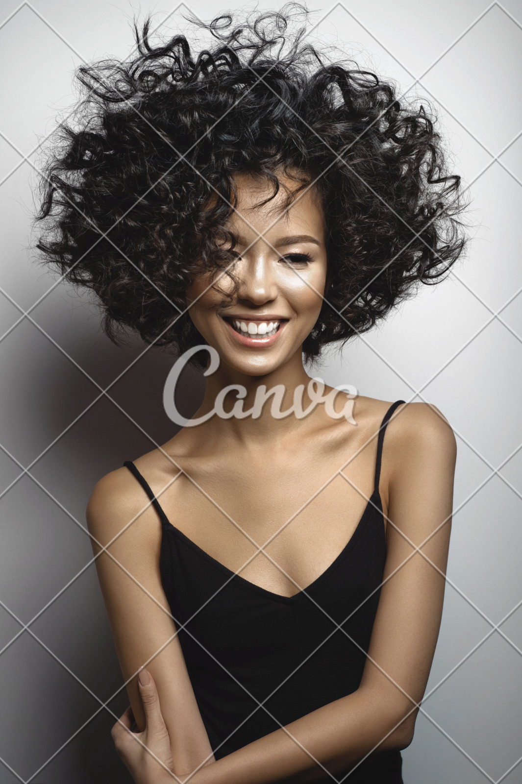 Smiling Woman In Black Dress With Afro Curls Hairstyle