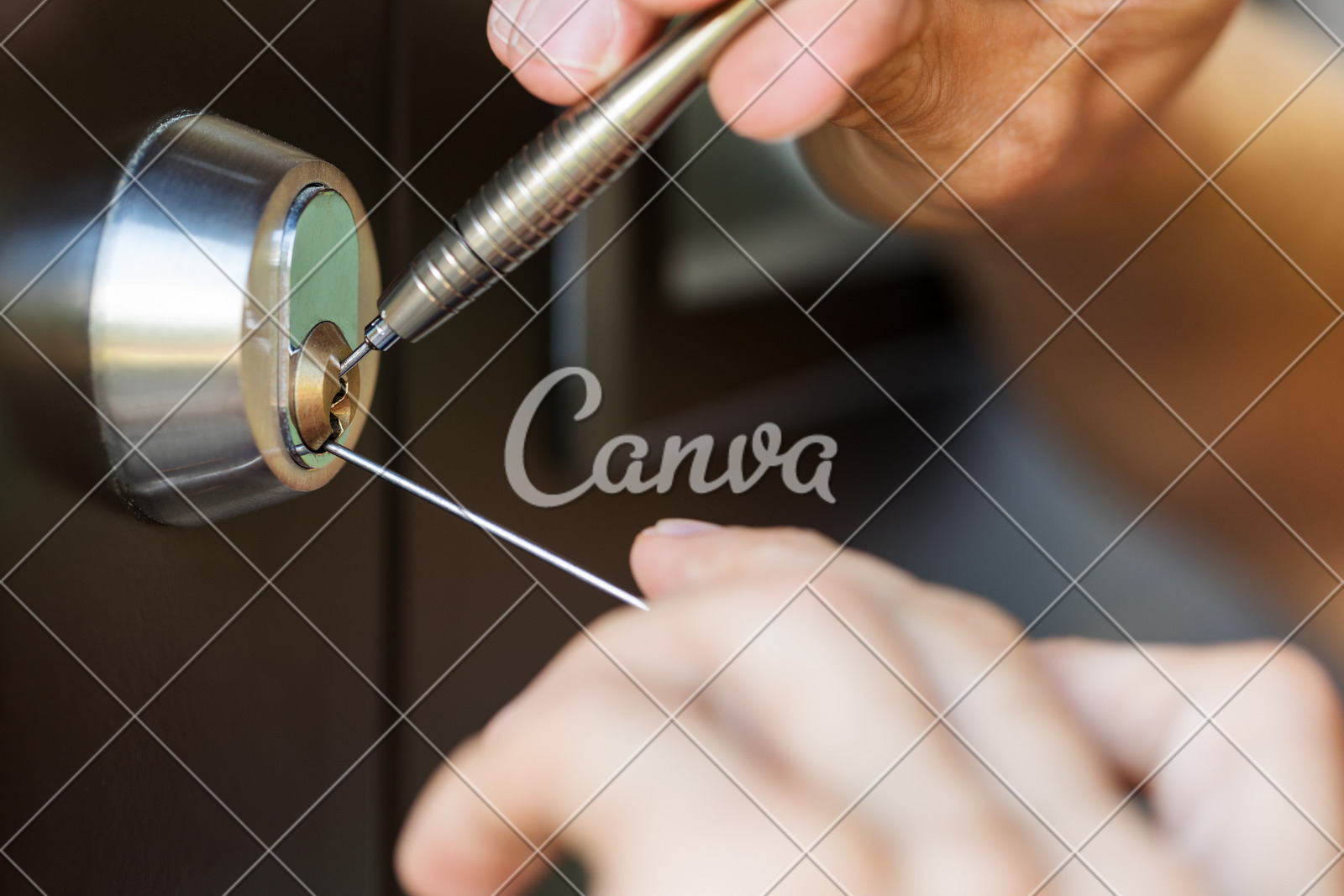 Closeup Of Locksmith Hands Using Pick Tools To Open Locked