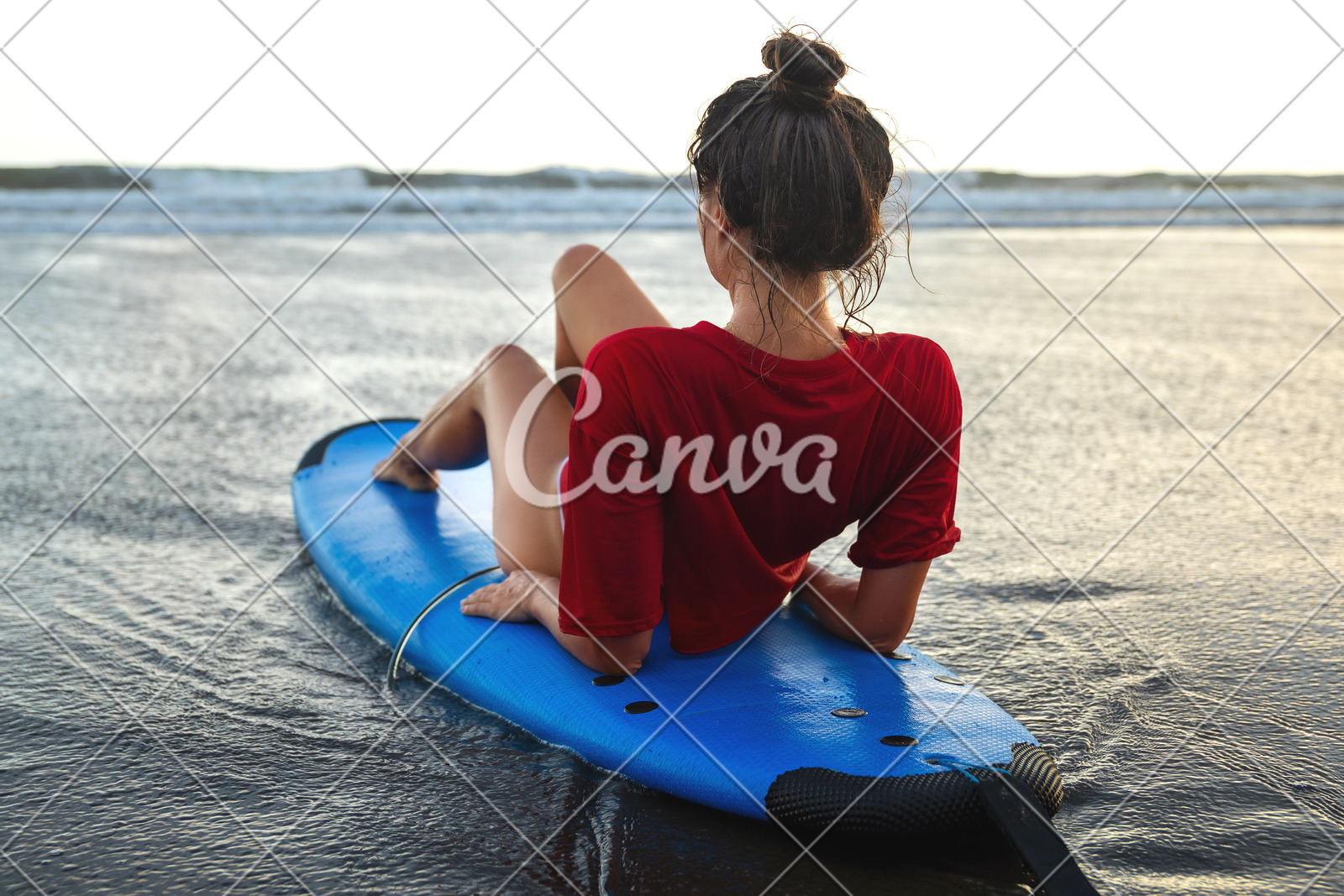 Woman Sitting On Surfboard On The Beach After Her Surfing