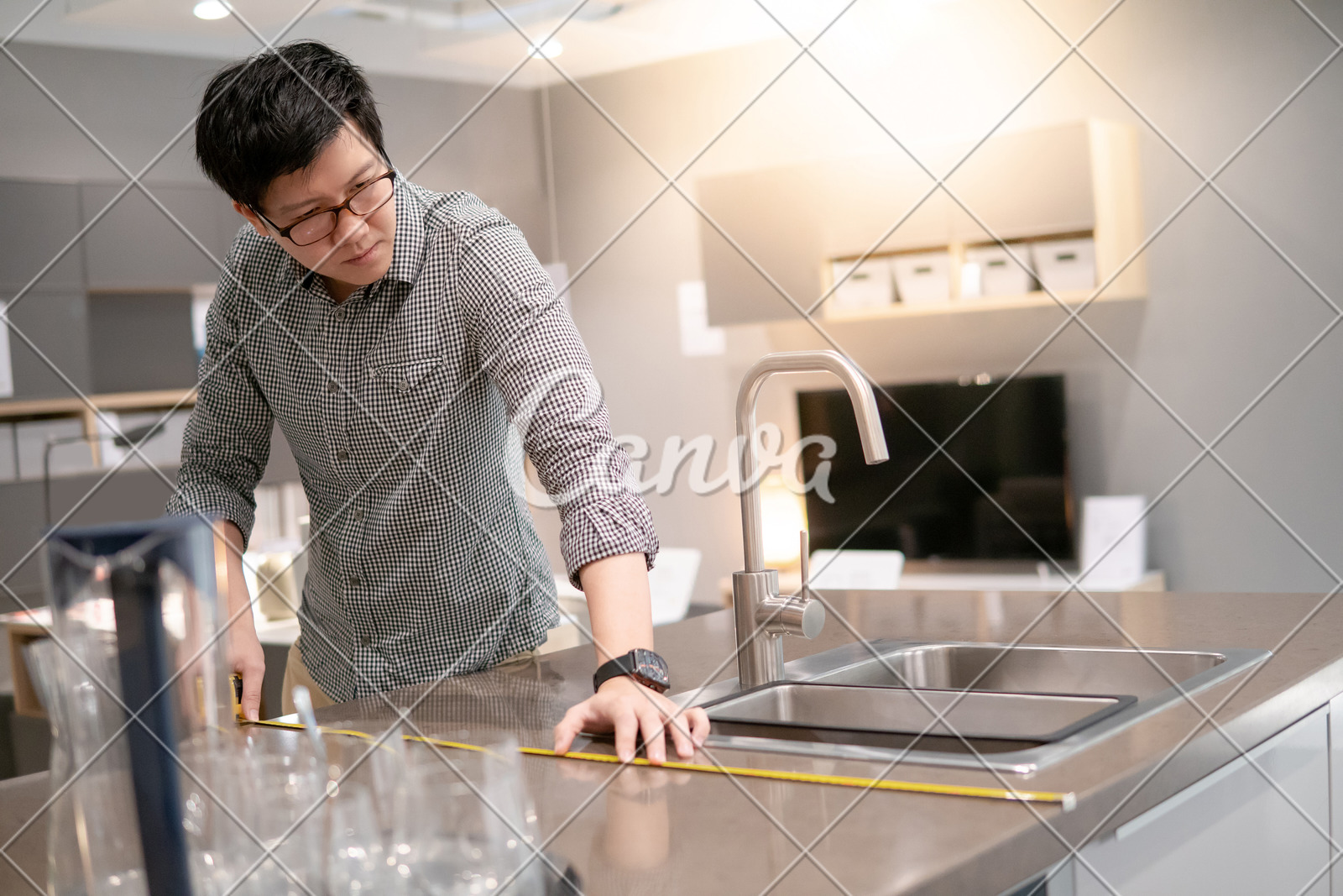 Young Asian Man Using Tape Measure For Measuring Granite