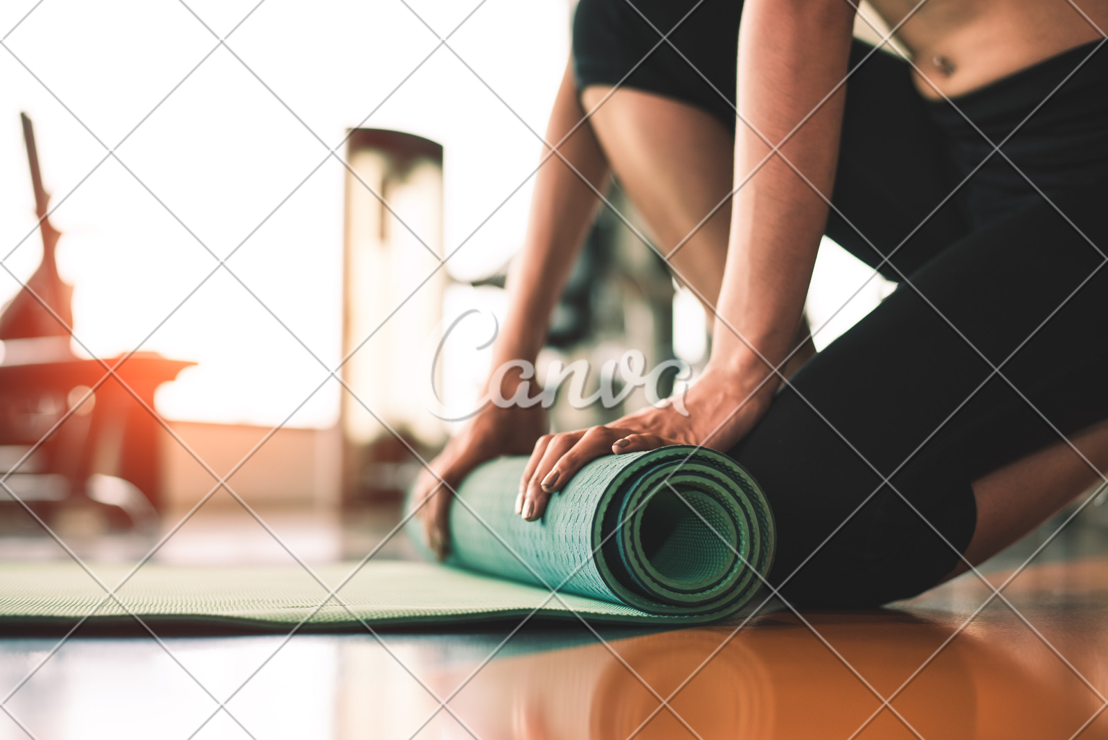 Close Up Of Sporty Woman Folding Yoga Mattress In Sport Fitness