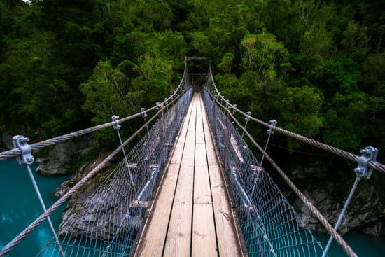 Rope Swing Bridge Over Blue River In Abel Tasman New