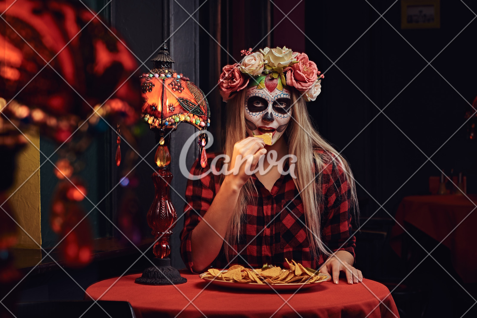 Young Blonde Girl With Undead Makeup In Flower Wreath Eating