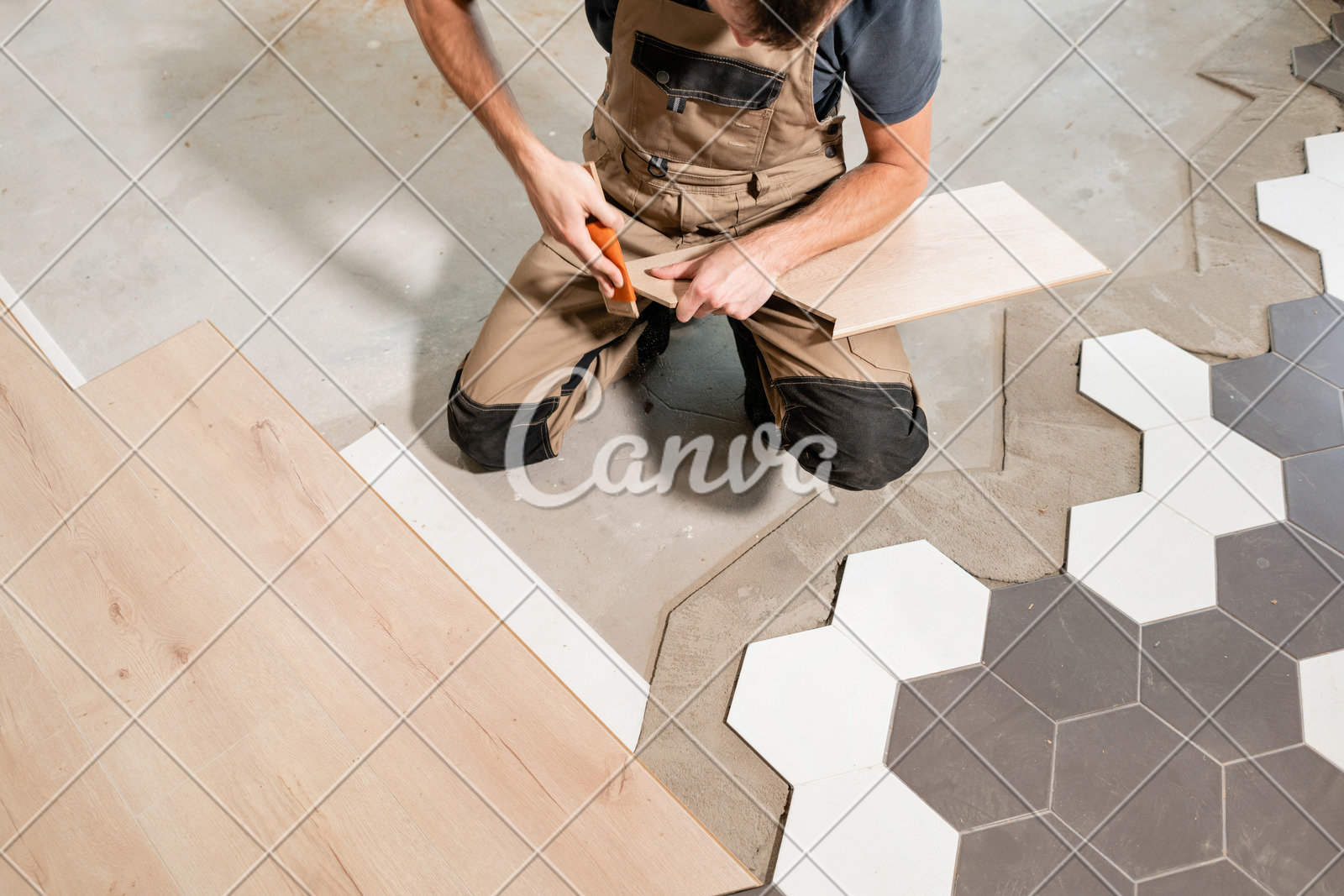 Male Worker Installing New Wooden Laminate Flooring The