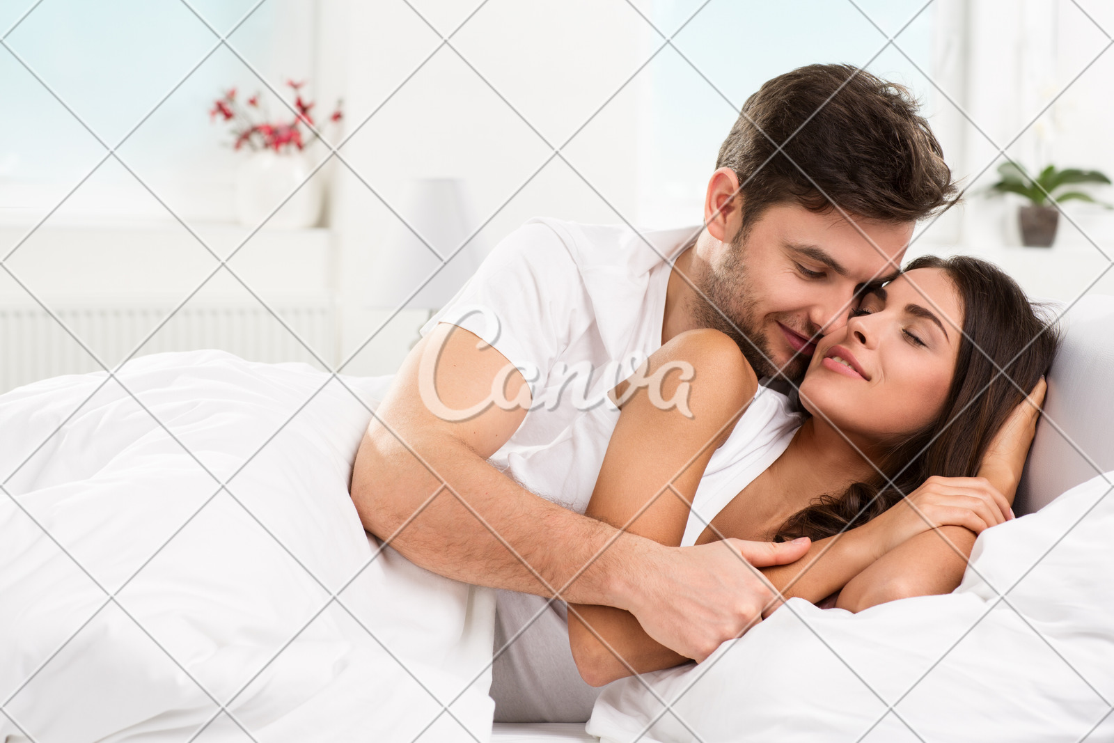 Young Adult Couple Cuddling In Their Bedroom Photos By Canva