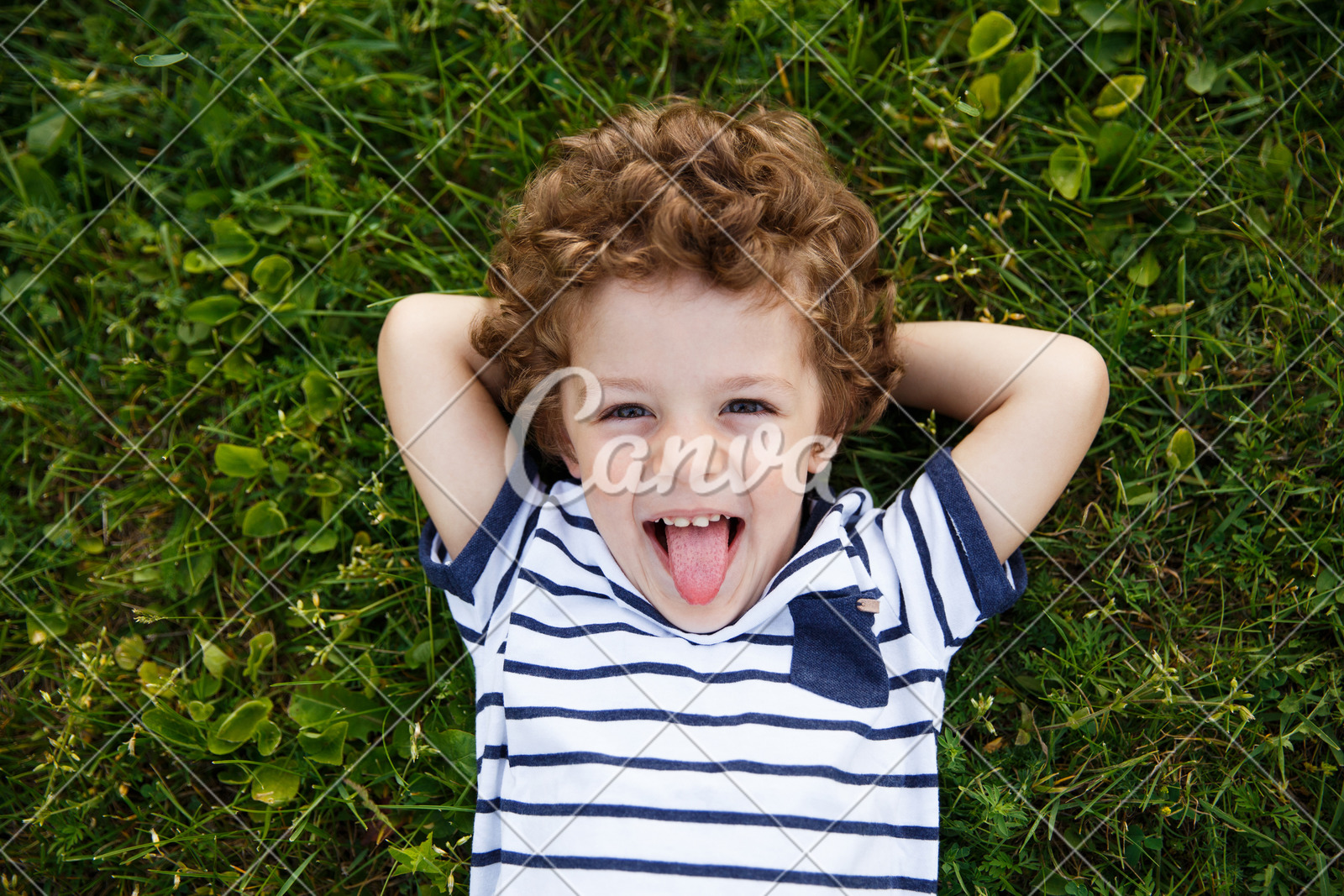 Curly Haired Boy Lying On Grass Photos By Canva