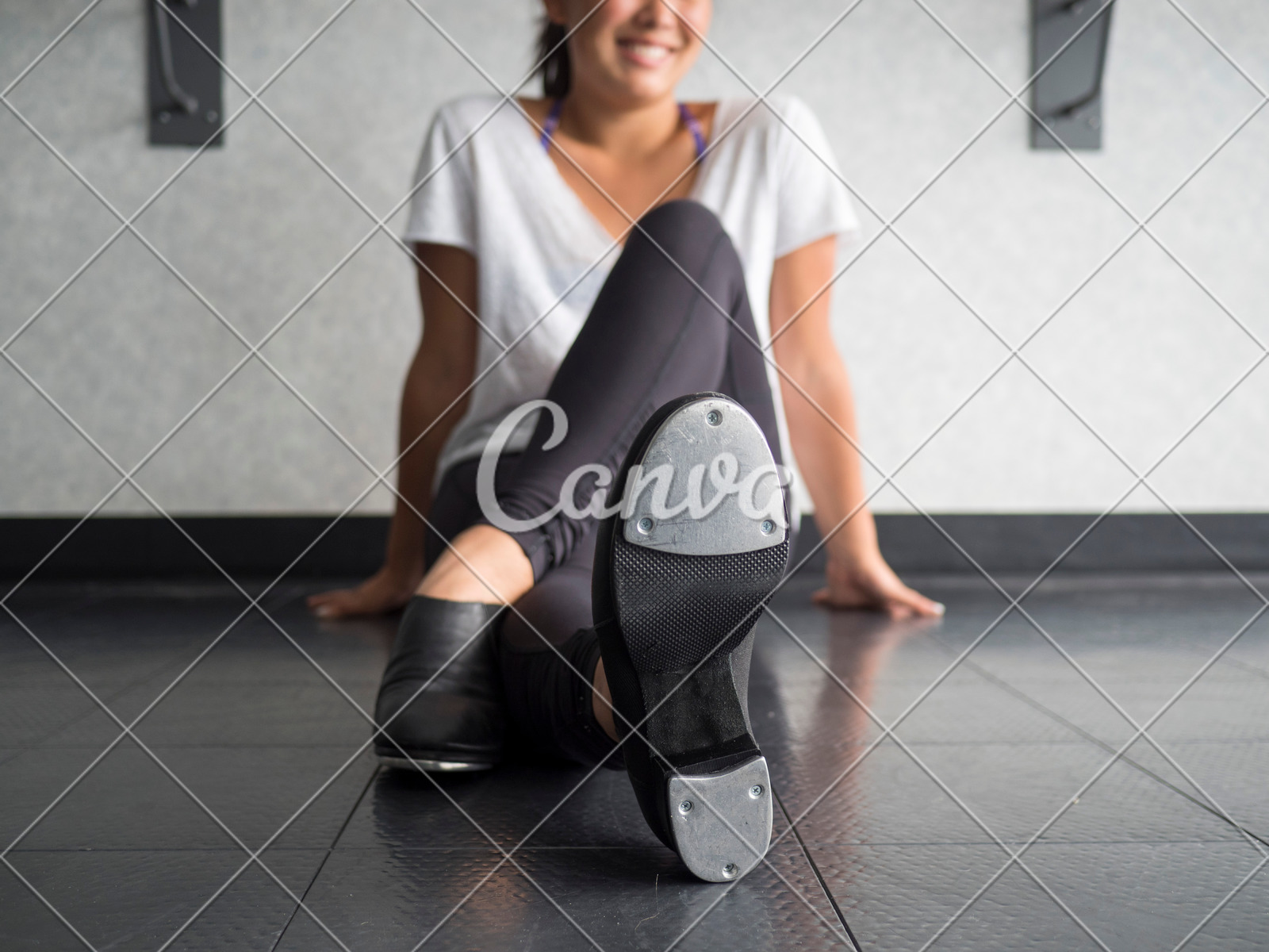 Smiling Teenage Tap Dancer Sitting Cross Legged In Dance Class