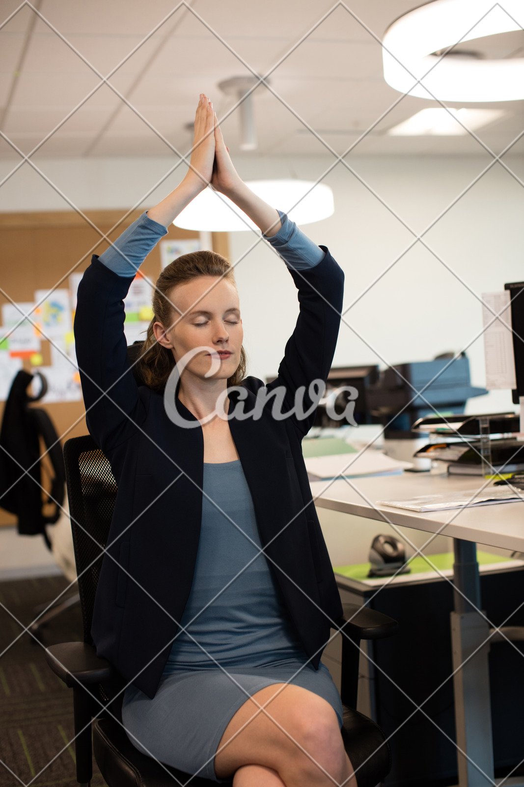 Businesswoman Practicing Yoga While Sitting On Chair Photos By Canva