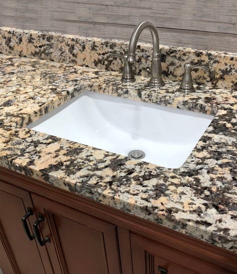 Granite Countertop On Bathroom Cabinet With White Rectangular