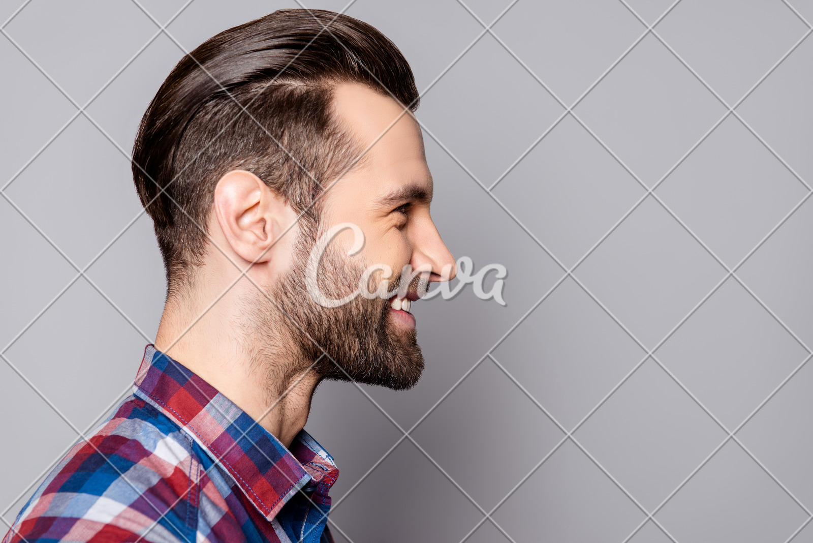 A Side View Portrait Of Young Handsome Smiling Man With Stylish