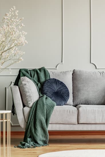 An Elegant Navy Blue Sofa In The Middle Of A Bright Living