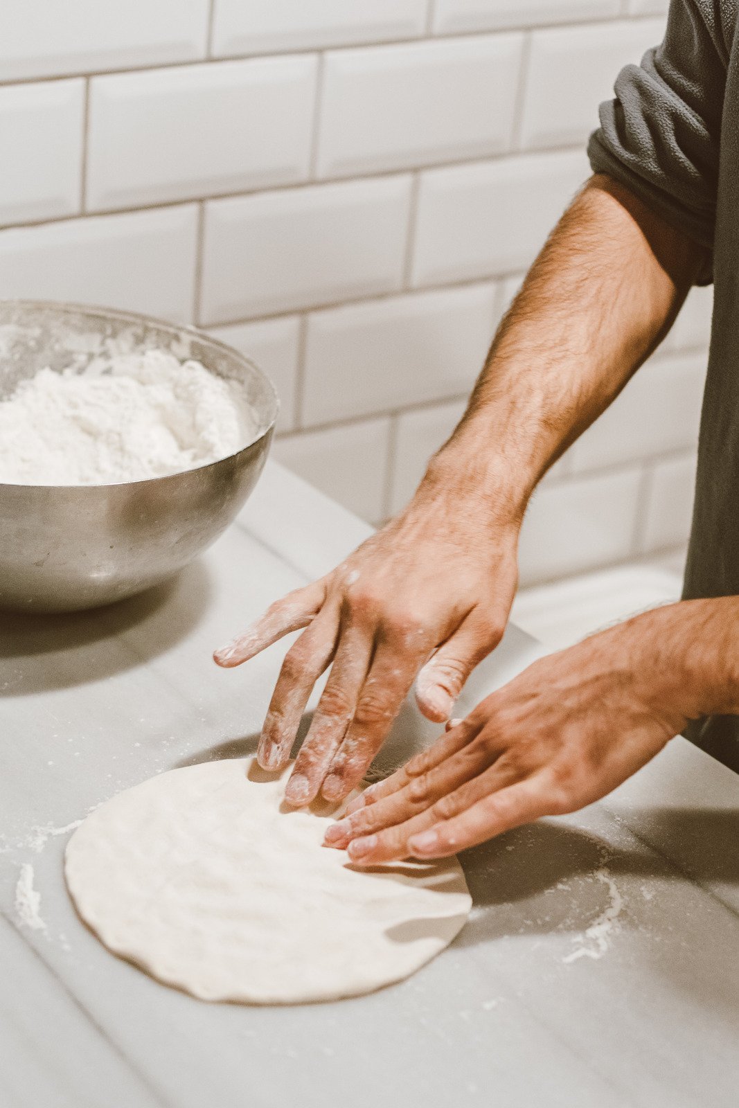 A Person Kneading the Dough Photos by Canva