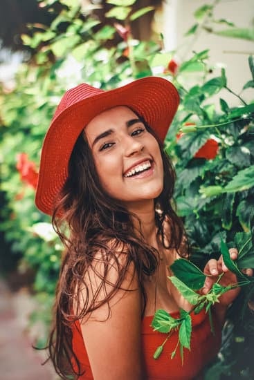 Happy woman standing near green bush