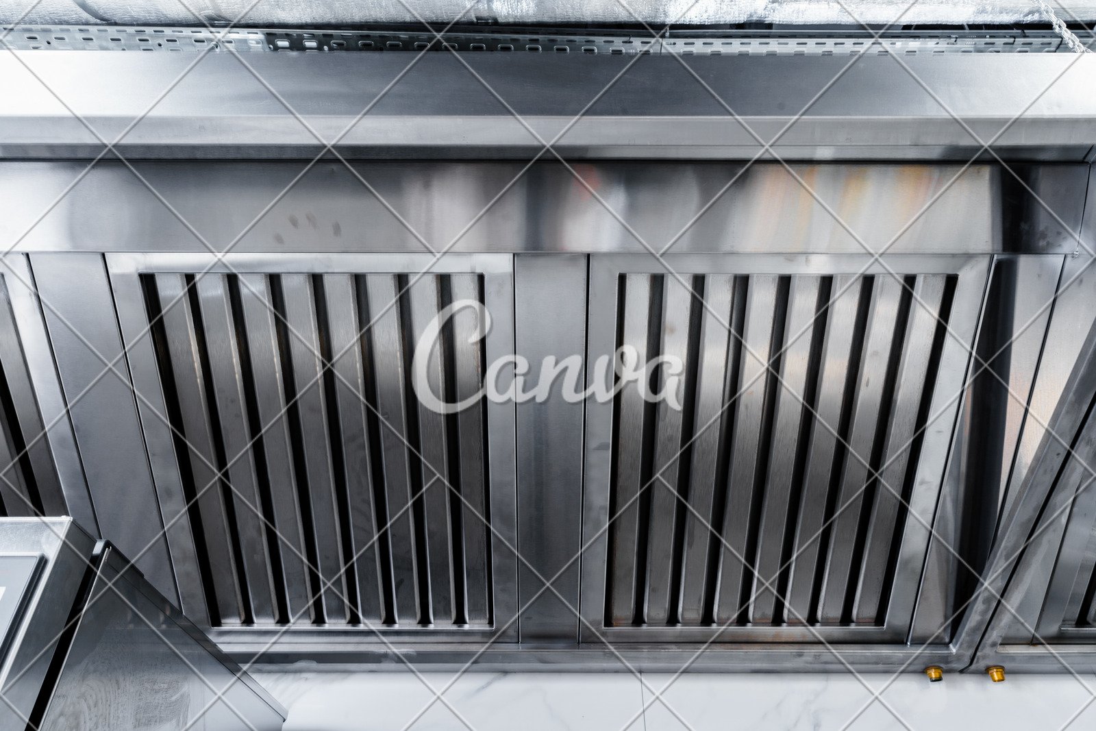 New clean stainless steel hood in professional kitchen Photos by Canva