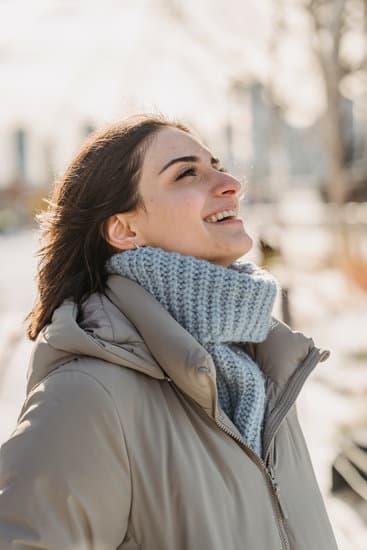 Happy woman in outerwear on street